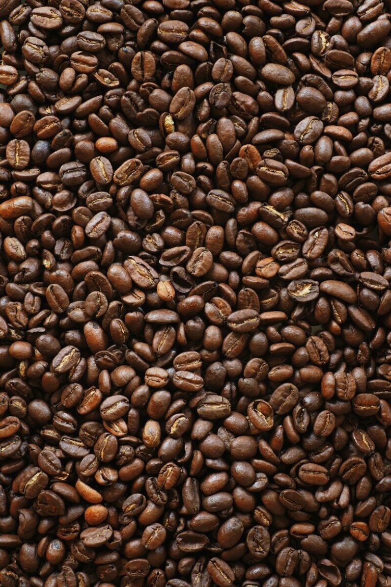 brown coffee beans on black surface